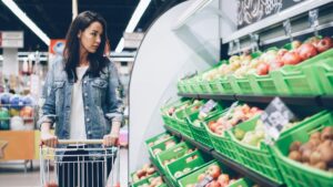 Woman shopping for fruit in a grocery store.